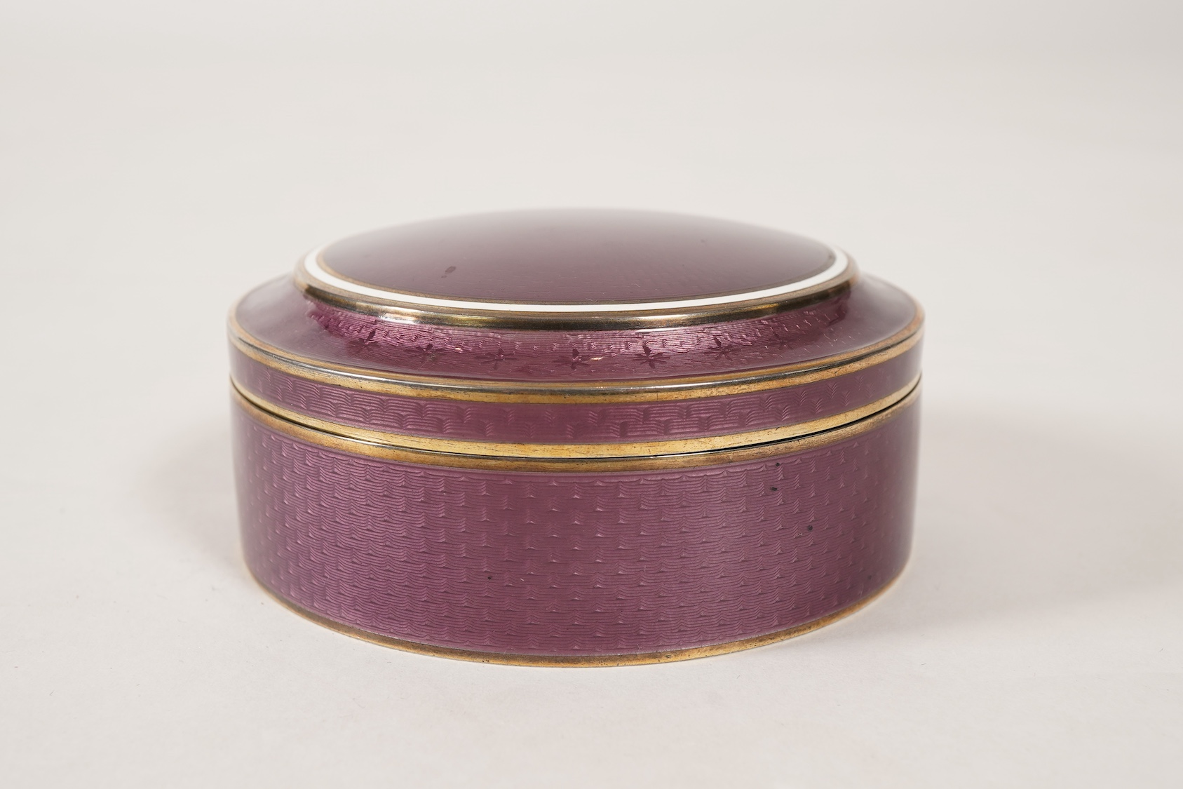 A late 19th/early 20th century North American sterling and mauve guilloche enamel circular box and cover, by Theodore B. Starr Inc, New York